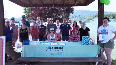 Volunteer table at the Float Fish Fry event held at Town Park in June of 2018